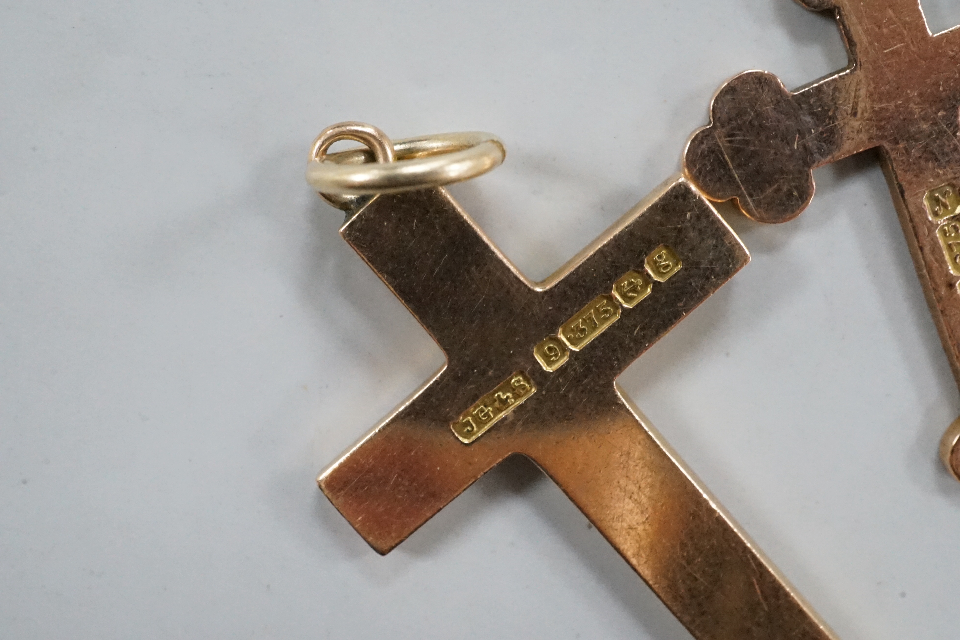 Two early 20th century 9ct gold cross pendants, three other 9ct charms including articulated fish, gross weight 11.8 grams.
